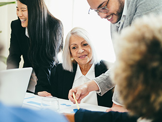 Older employee participating in a meeting with younger colleagues